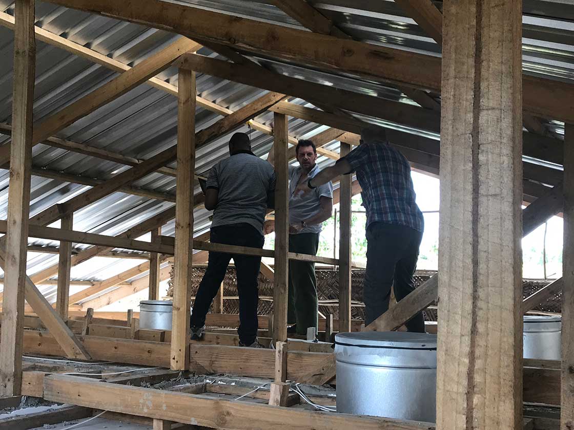 The team investigating the roof space of the test unit which is used for passive stack ventilation aided by a gap in the ceiling