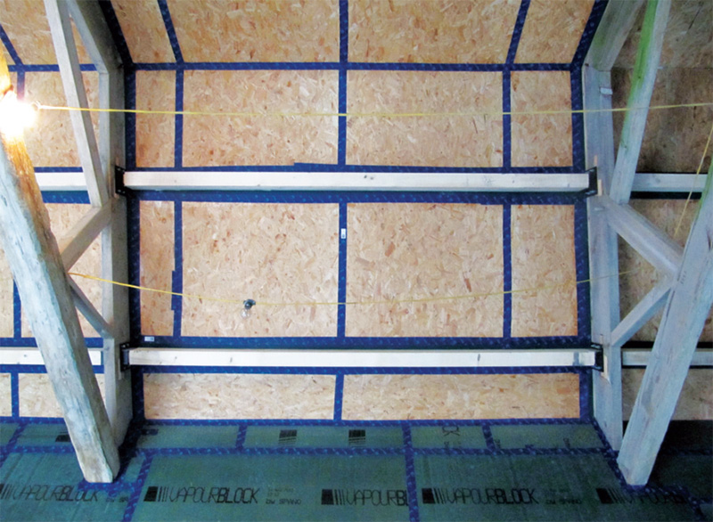 The Spano boards in the walls line up with OSB in the roof — which is taped with Pro-Clima tapes — to create a continuous airtight layer