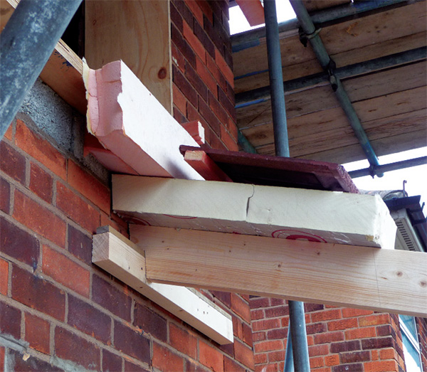 A wall to pitched roof insulation detail