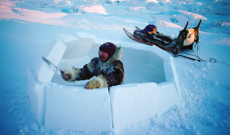 International - Qaaviganguaq Qissuk an old hunter Inuk uses a snow knife to build an igloo in northwest Greenland