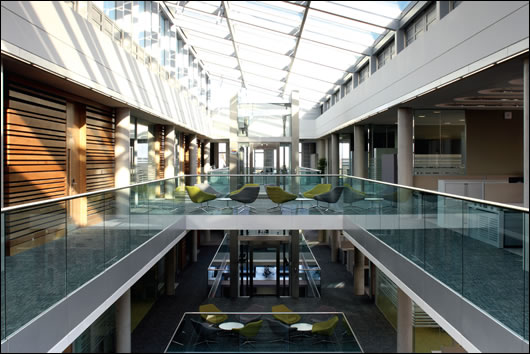 The offices are set around a large central atrium which aids ventilation and greatly increases natural light, with the added benefit of glazed balustrades