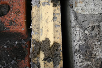 Partial-fill cavity wall construction, shown here with thermal performance severely compromised, is being used in innumerable cases where the application of more innovative systems and products is being obstructed