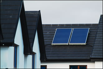 Two flat-plate solar panels on each roof look ater approximately 60% of annual hot water requirements