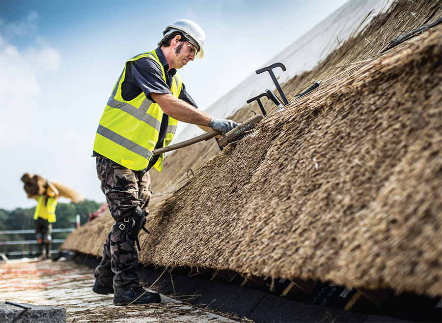 The thatch cladding is perhaps the most distinctive feature of this building; three hundred panels were manufactured and thatched off-site, and the panels then hooked onto horizontal battens lining the perimeter of the building. The building also features a wide array of other sustainable materials including recycled timber finishes, wood wool acoustic boards, spray-on cellulose, and wall coverings made from hemp, nettle fabric and reeds