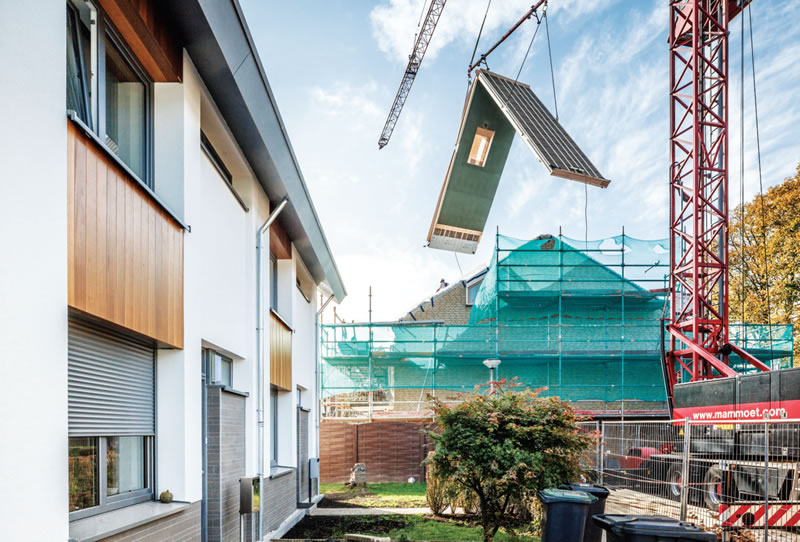 Prefabricated roofing with integrated roof lights being craned into position