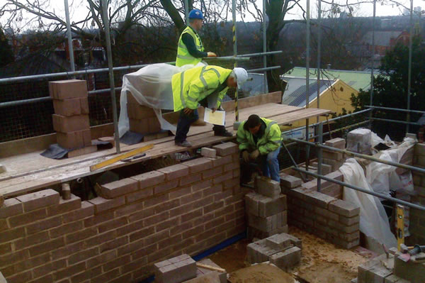 Neopor insulation fitted around frameless glass windows on the rear elevation