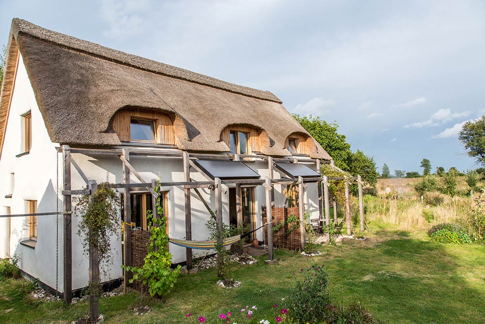 The roof of the cottage is finished with local reed thatch