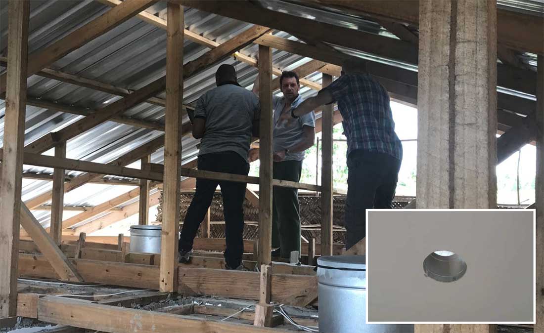 The team investigating the roof space of the test unit which is used for passive stack ventilation aided by a gap (inset) in the ceiling