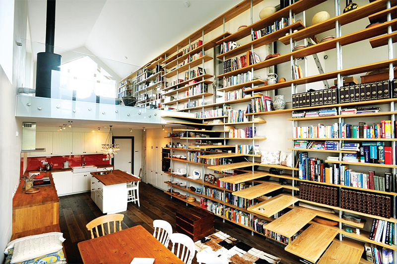 The house is divided into two living spaces, public and private, separated by a library wall with its own secret doors. A glass balustrade is yet to be installed