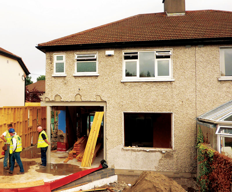 The stick built timber frame extension being built