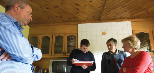 (above, left to right) Stephen Harte, Paul Kenny, Francis and Margaret Murray - Kenny goes through the local installer list with the Murrays