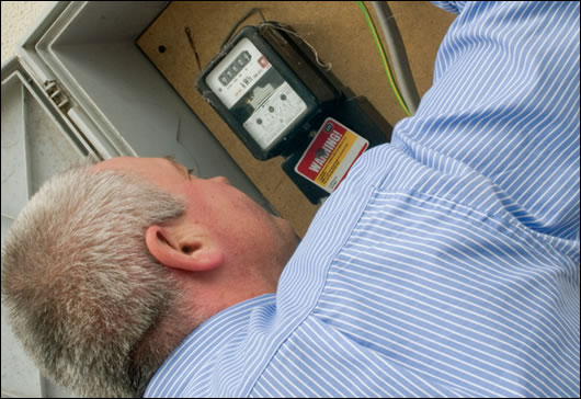 Stephen Harte checking the meter box to try to see what sort of insulation is in the cavity