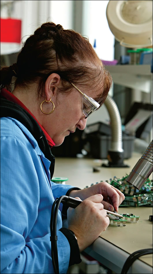 fumes produced from soldering in the factory are drawn directly from workbenches to a mechanical ventilation heat recovery unit outside