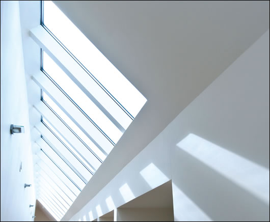 Twenty-four glazed panels run along the roof, allowing light into both the corridor and the adjoining living areas