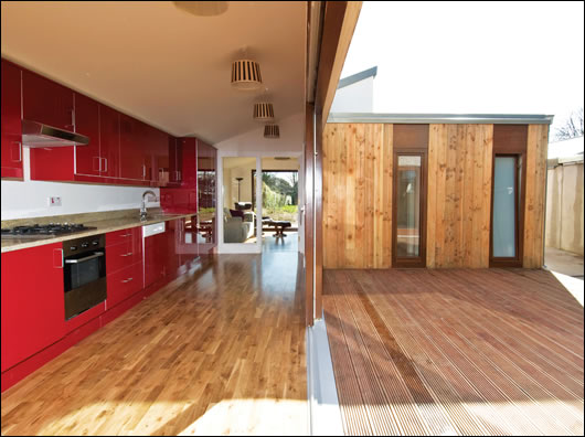 The galley kitchen is at the front of the extension and forms the western flank of the courtyard, leading into the living room